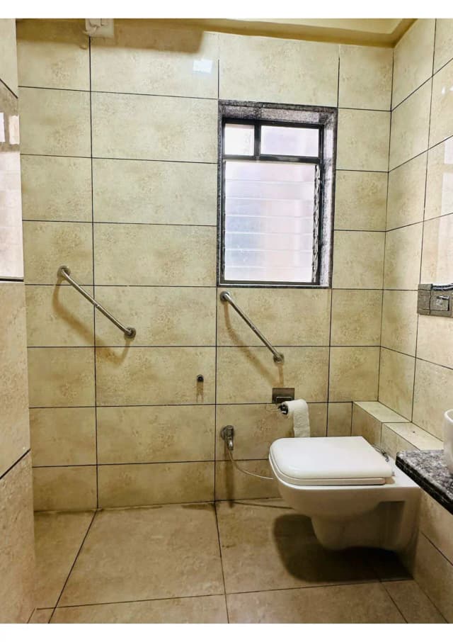 Twin sharing rooms with modified spacious toilet with grab bars, reachable cupboard and drawers, wide doors.