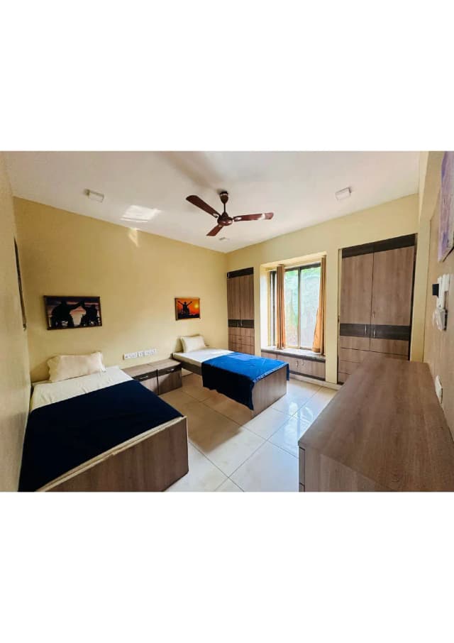 Twin sharing rooms with modified spacious toilet with grab bars, reachable cupboard and drawers, wide doors.